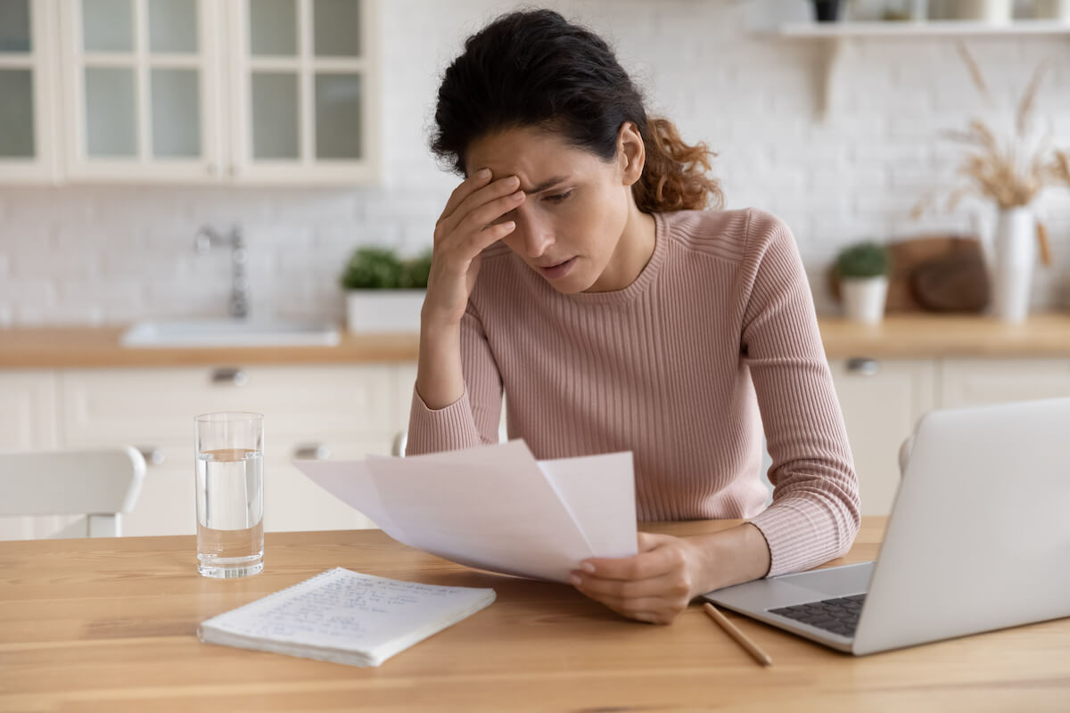 Timeshare Termination Team: stressed woman reading some documents
