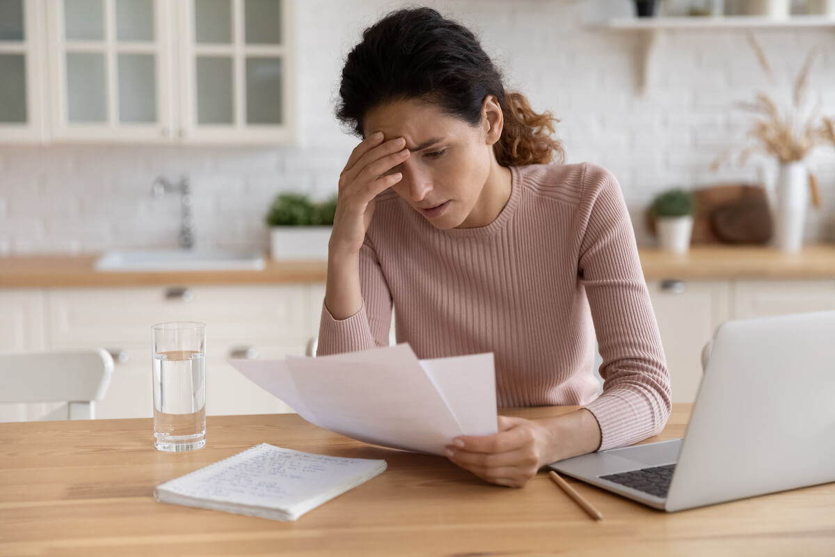 Timeshare Termination Team: stressed woman reading some documents