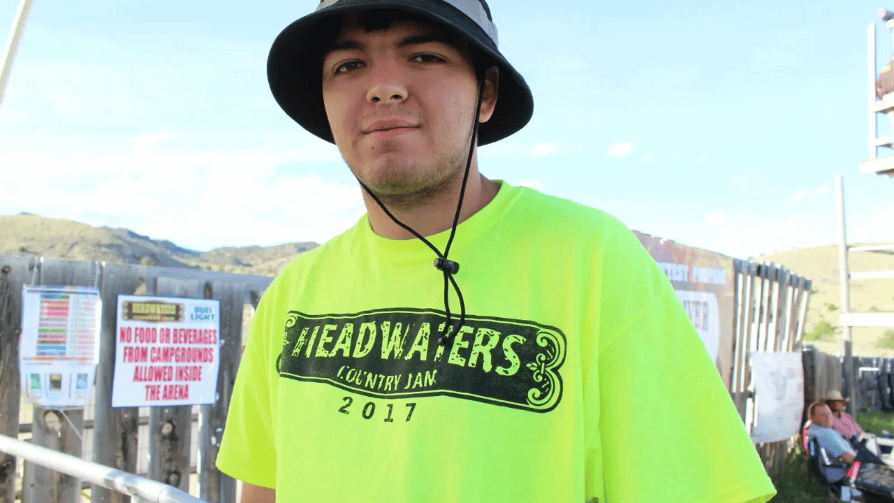 A guy wearing headwaters country jam tshirt during the event. 