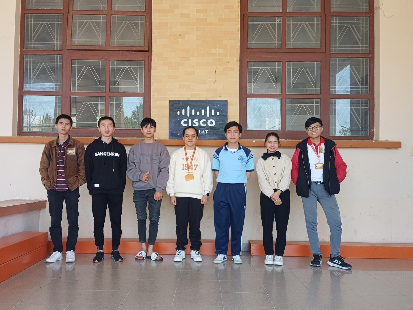 A group of people standing in front of a building

Description automatically generated