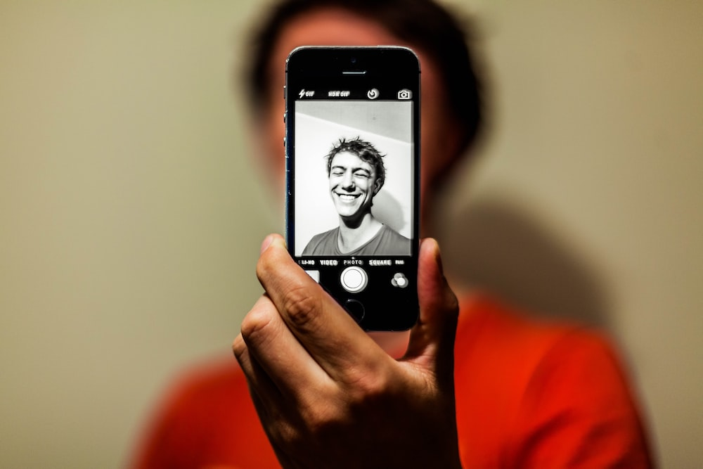 A Person Capturing His Selfie By Posing With a Smile on Face