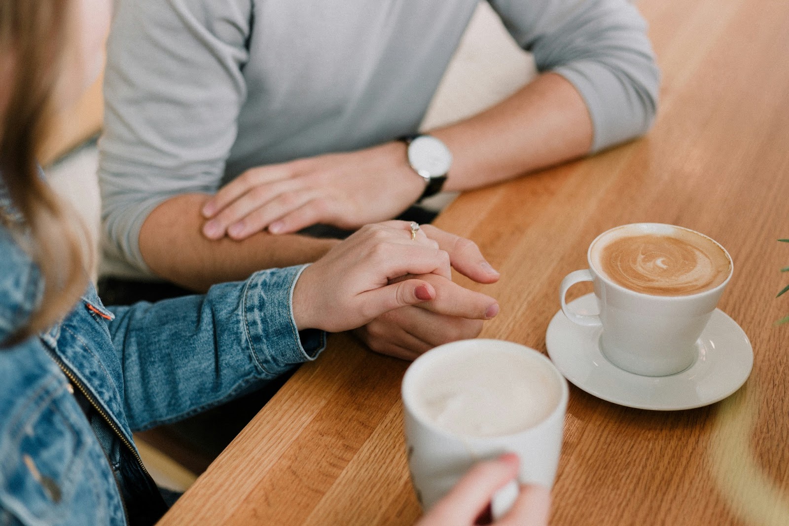 A couple discussing honeymoon plans over a cup of coffee. 