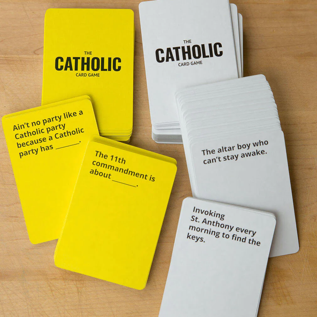 The Catholic Card Game with a bunch of yellow and white cards on the table.,m,                                                                 