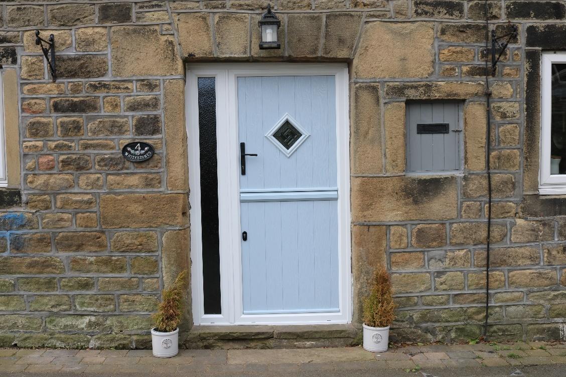 A blue door in a stone building

Description automatically generated