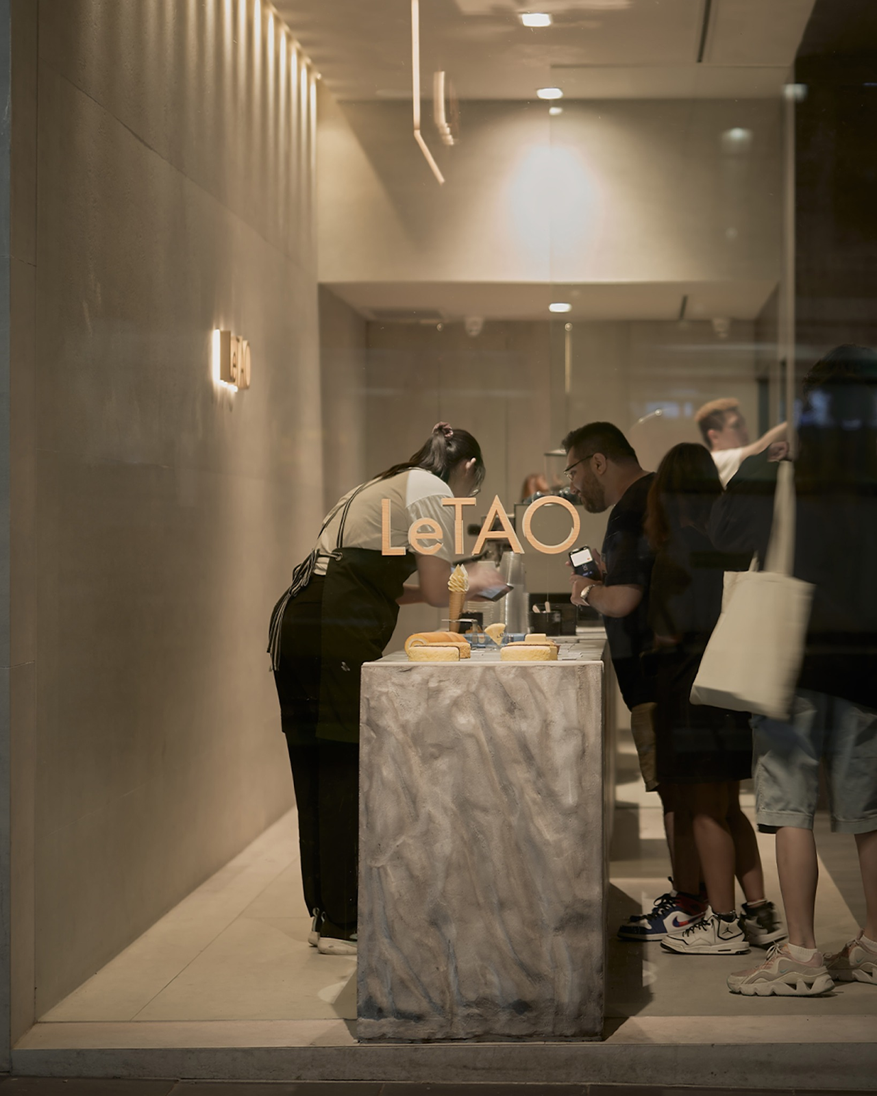 Customers buying dessert at LeTAO