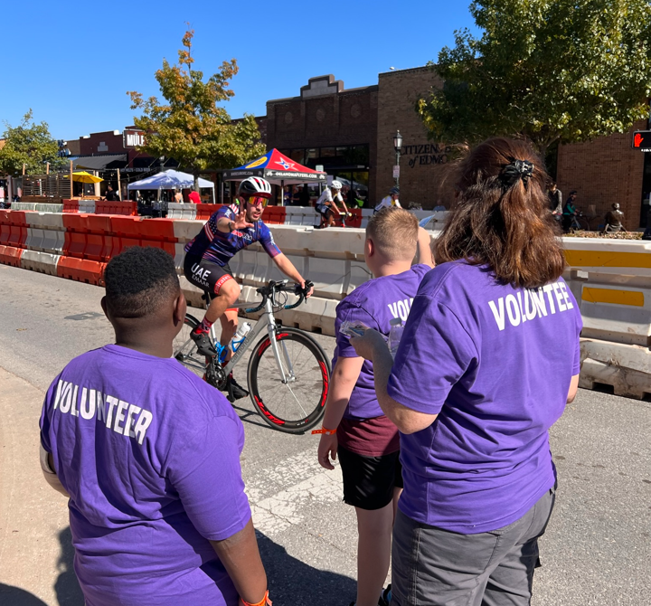 A group of people in purple shirtsDescription automatically generated