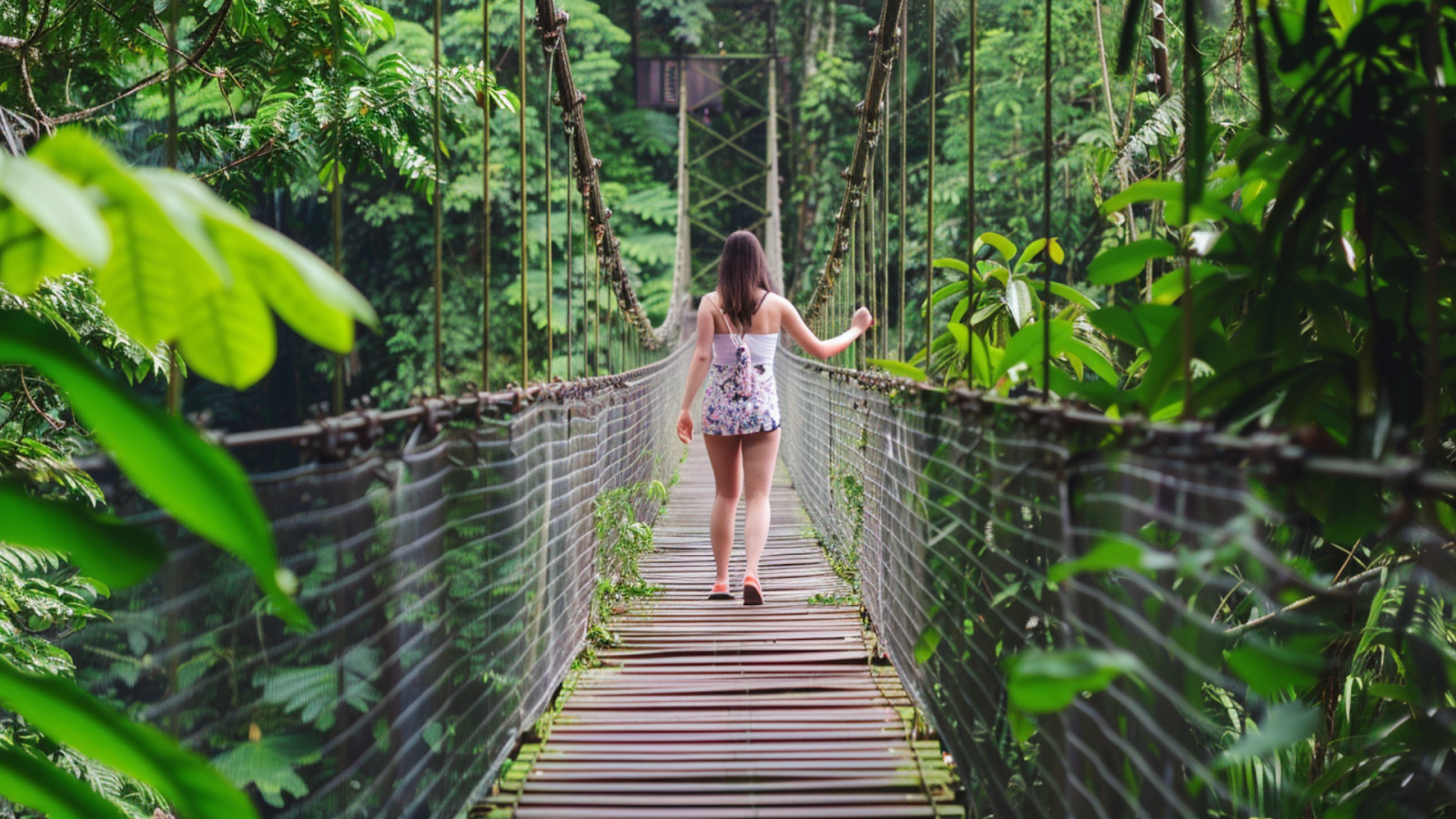 A woman crossing a hanging bridge in Costa Rica
