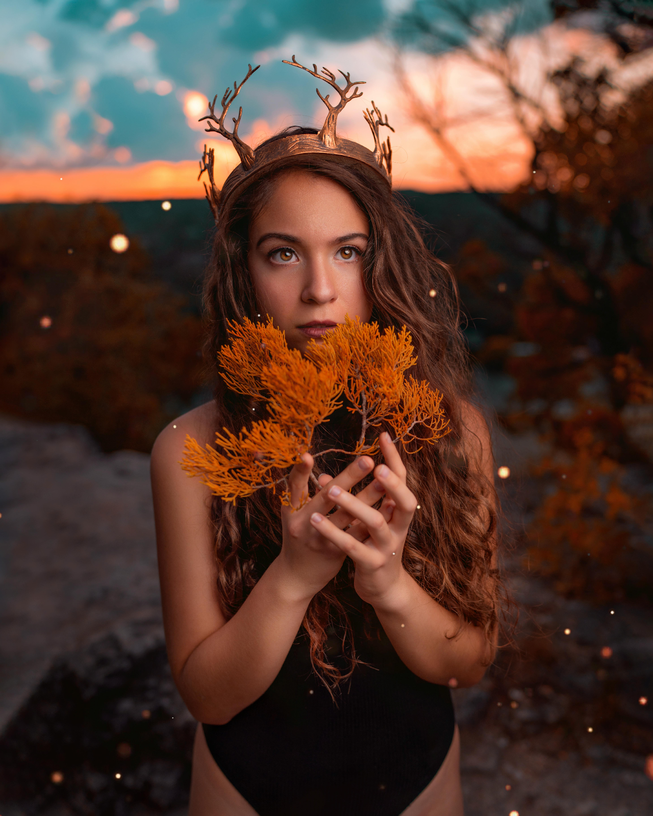 Stunning Girl With Crown on Head and Flowers in Hand