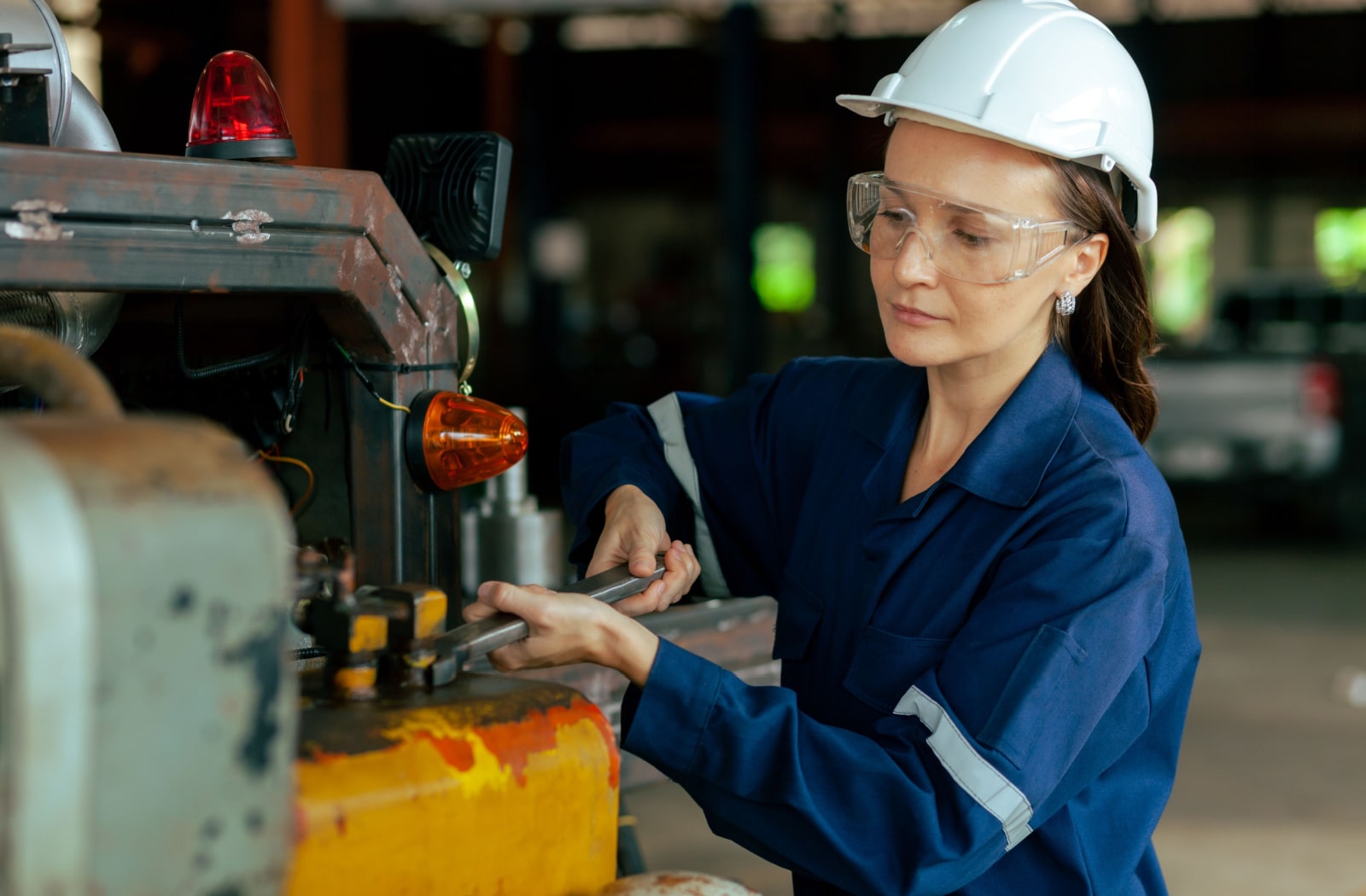 A female mechanical engineer working while wearing prescription safety glasses