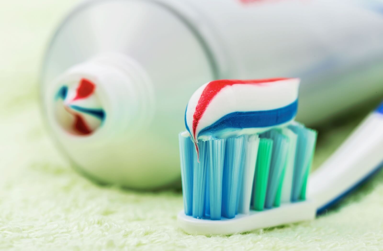 A close-up of a small of dab of fluoride toothpaste on a toothbrush.
