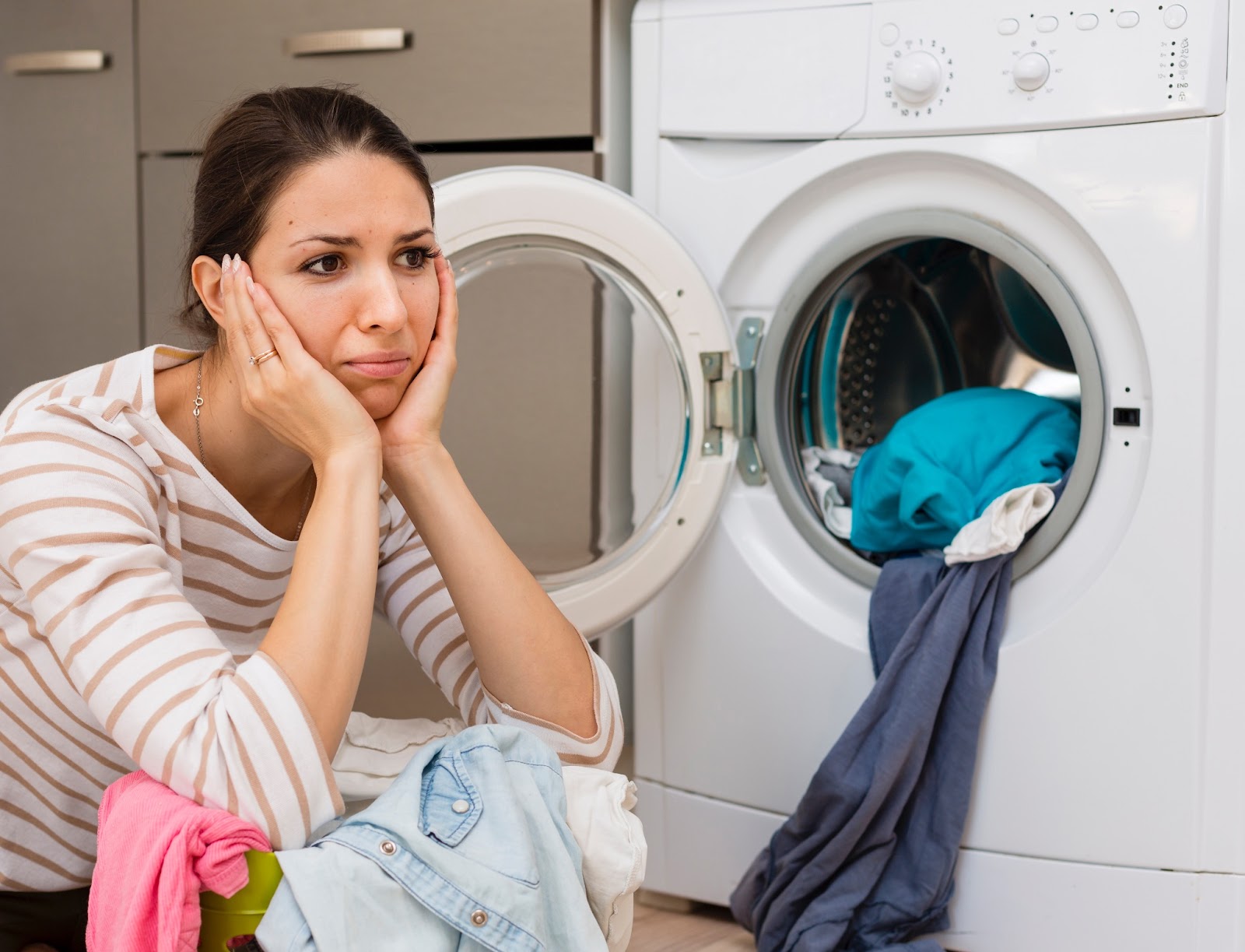 Stressed woman overloading the washer