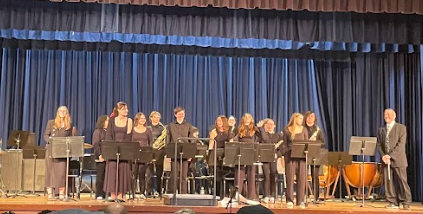 Picture of students standing for a final bow to audience in winter concert
