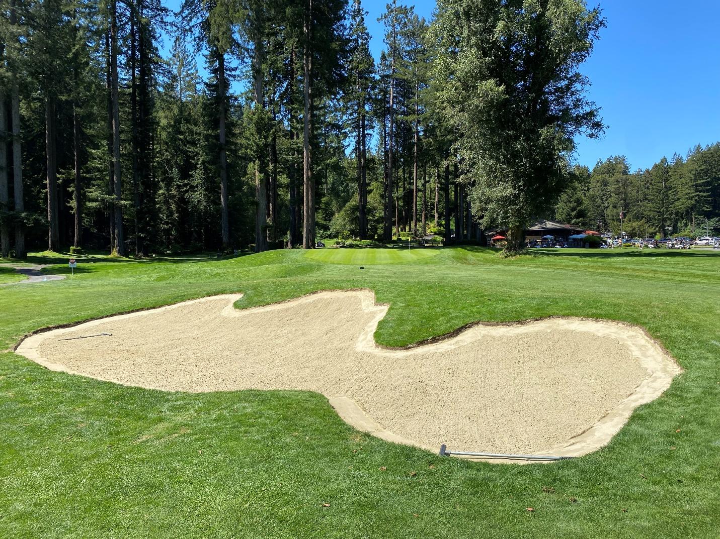 A sand bunker on a golf course

Description automatically generated