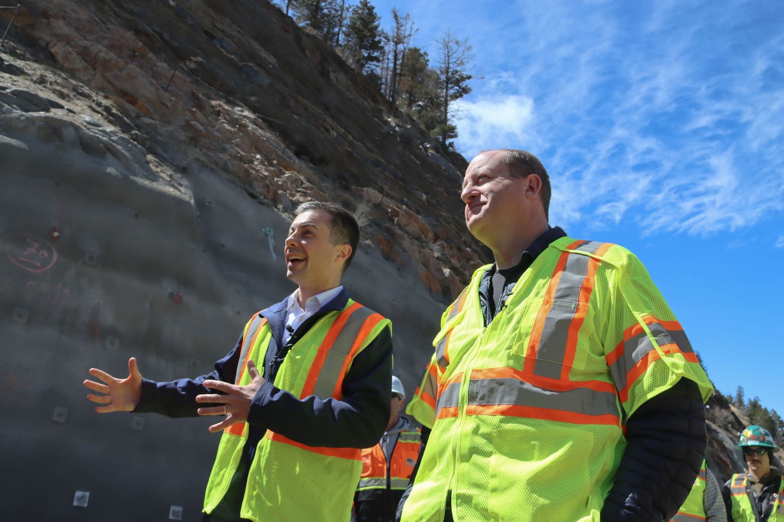 Governor Polis and Department of Transportation Secretary Pete Buttigieg speak at the Floyd Hill construction site.