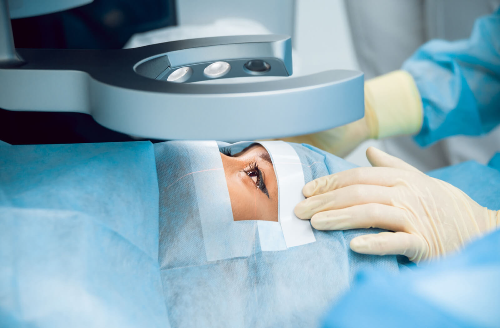 A close-up of a person undergoing laser surgery for her eyes.
