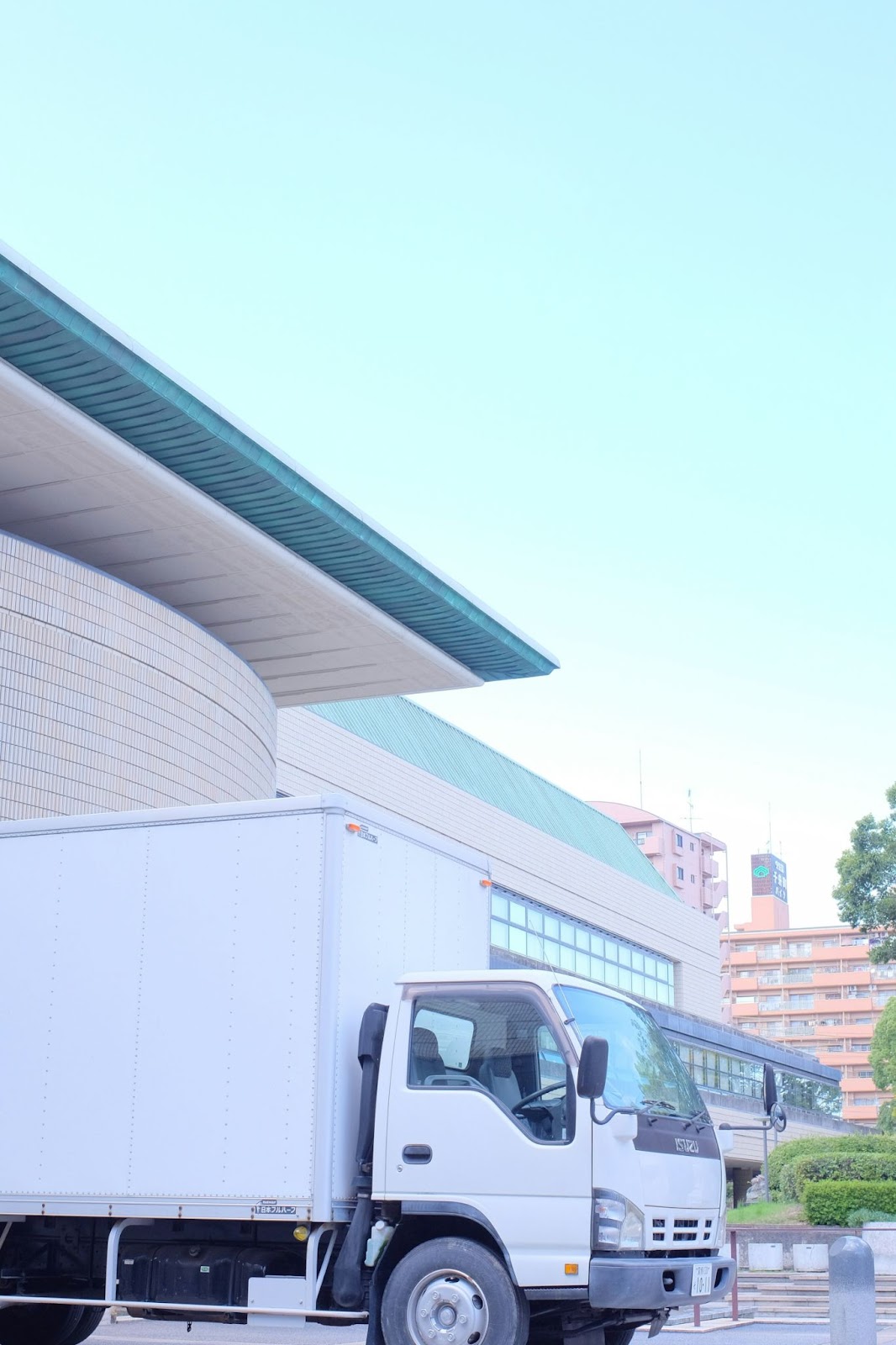 A white box truck parked outside of a building