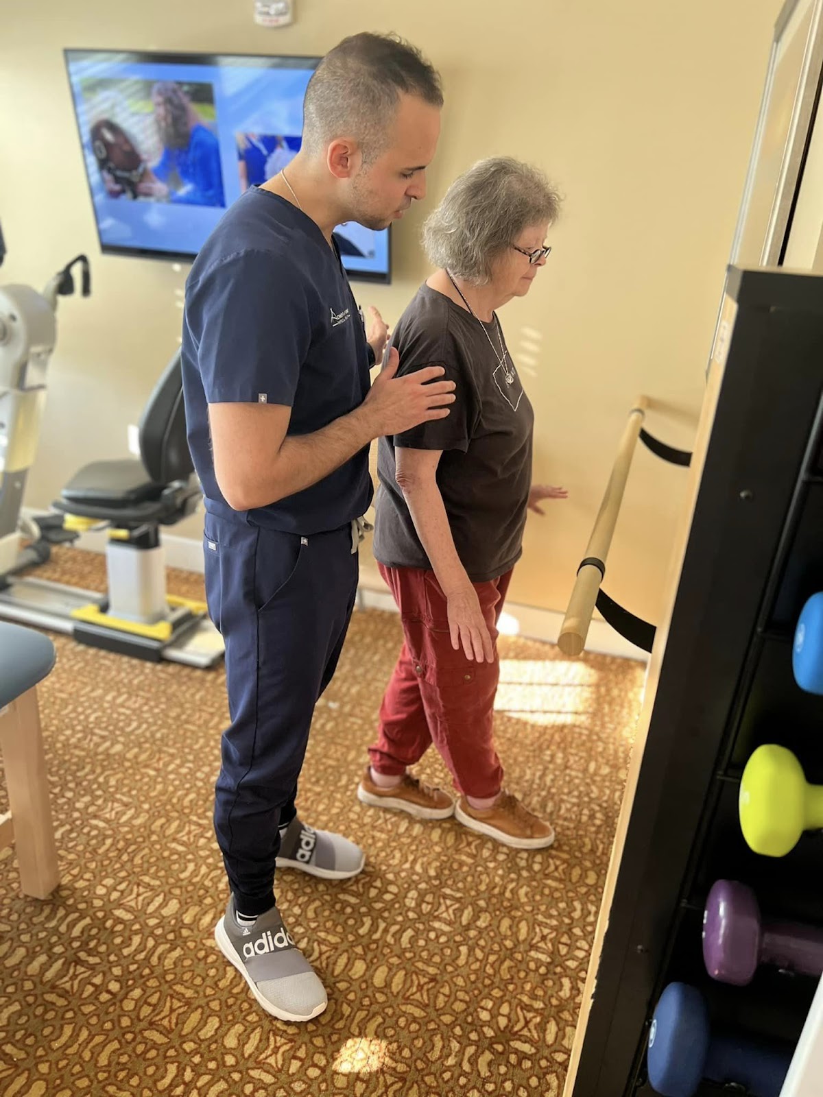 A healthcare professional providing physical therapy care to a resident in an assisted living facility
