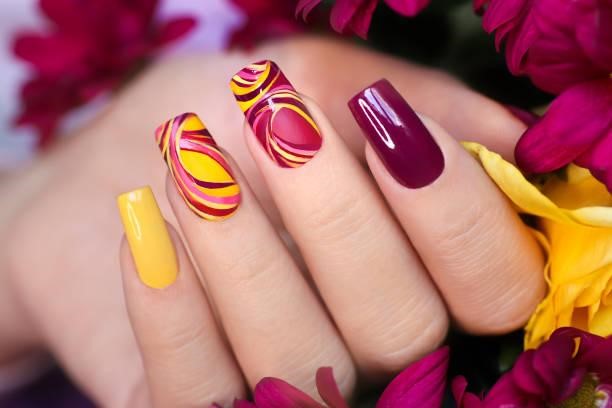 Fashionable multicolored manicure. Nail design on shiny and matte nail Polish with smooth curves.Fashionable multicolored manicure. Nail Art Designs  stock pictures, royalty-free photos & images