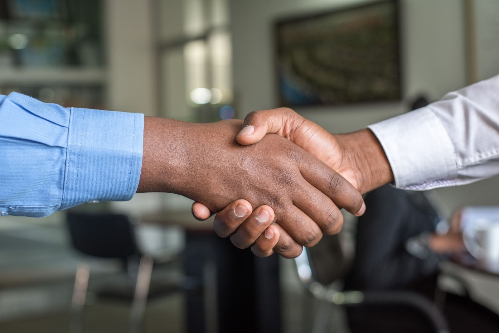 people shaking hands as if making a deal or sale for small businesses