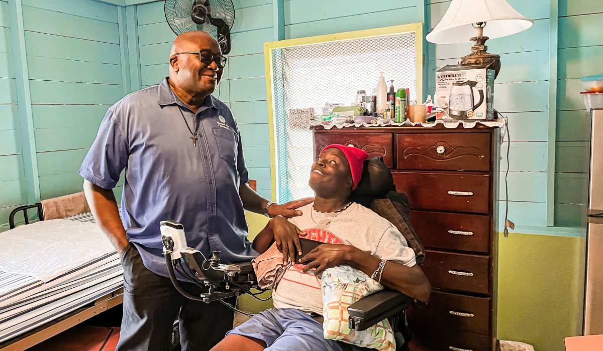 Lincoln, a 49 year old resident with cerebral palsy, enjoys his new space with Executive Director of MSC International, Fr. Garvin Augustine. 