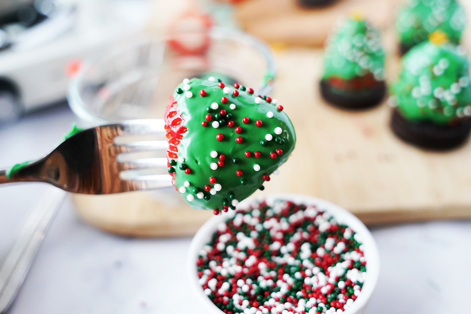 Immediately sprinkle candy covered strawberry with nonpareils. 