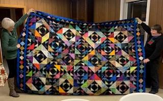 A colorful quilt on a counter

Description automatically generated