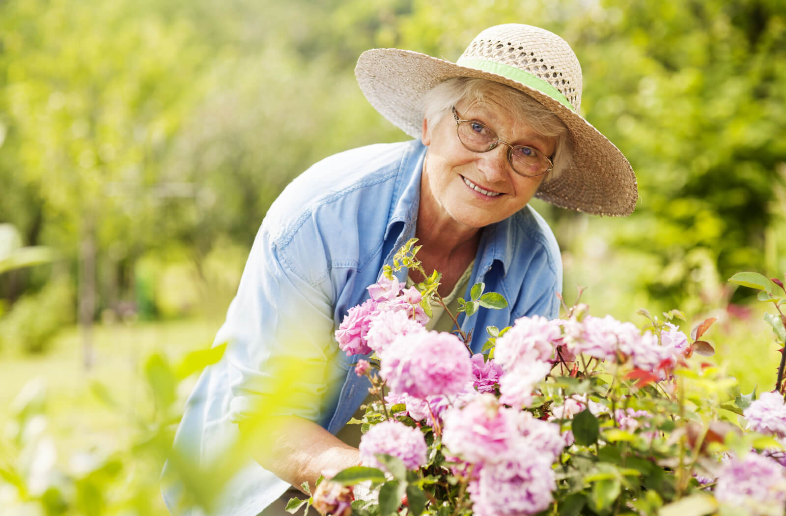 A senior woman tending to her flowers.