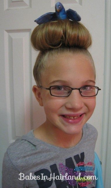 Picture of a girl wearing a top bun for crazy hair day 