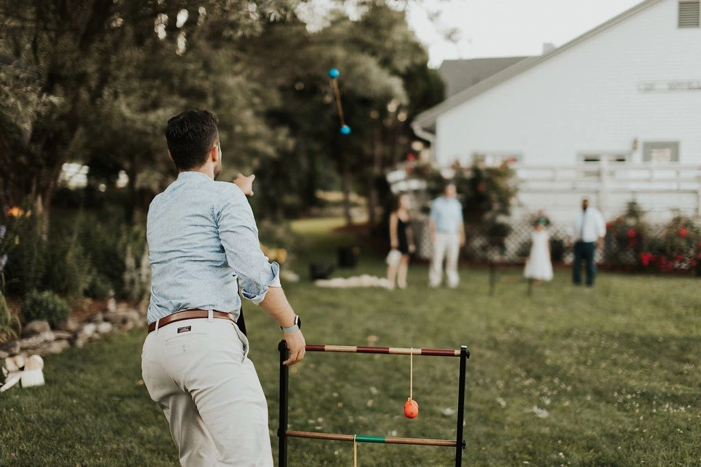 Wedding guests playing yard game