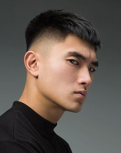 Side view of a guy rocking the stylish undercut with fringe, a popular korean haircut