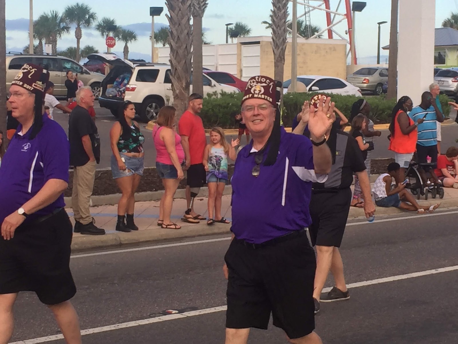 Image of Paul Weglage waving to camera at a Shriners parade in Florida.