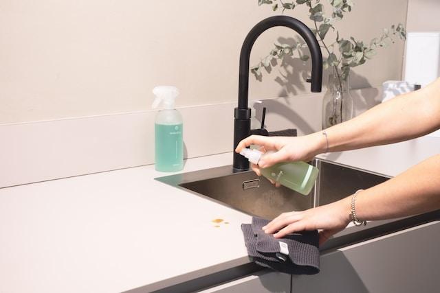 a person leaning a sink and drains.