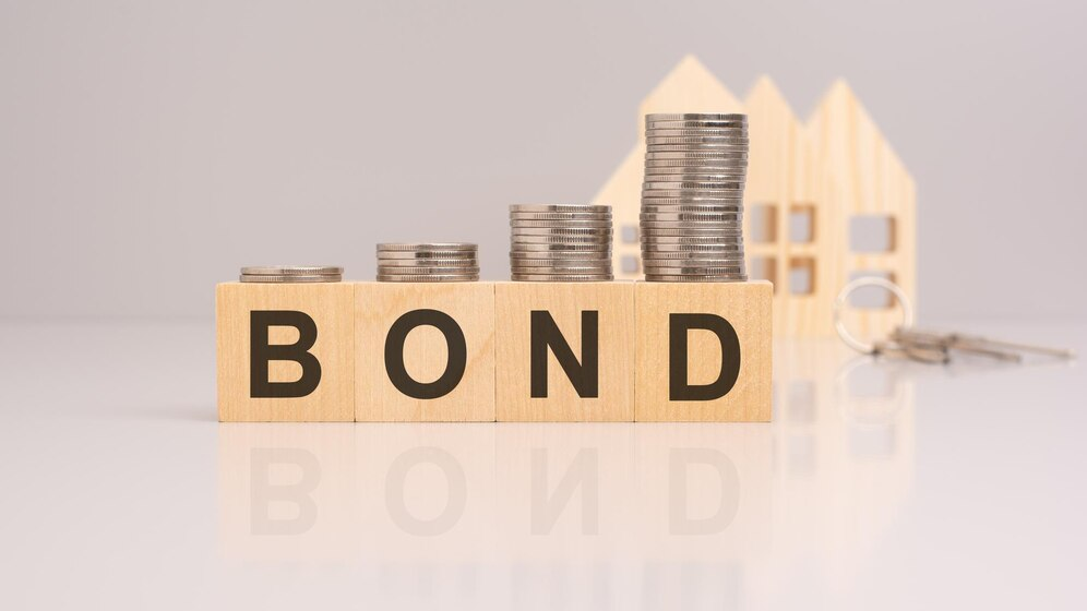 Crypto vs Bonds Wooden blocks with coins and text BOND with blurred wooden house models in the background