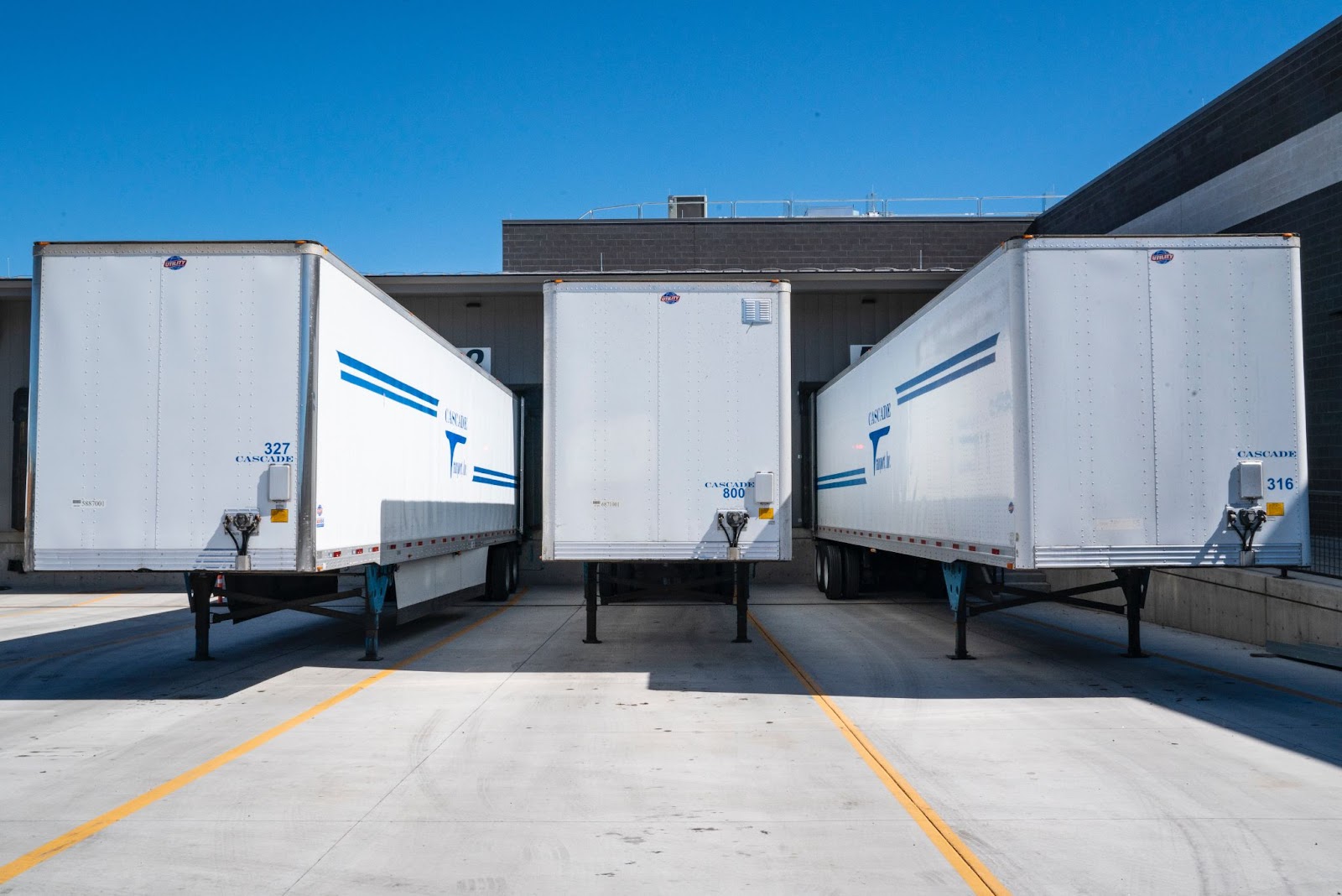 A row of semi trailers parked on concrete