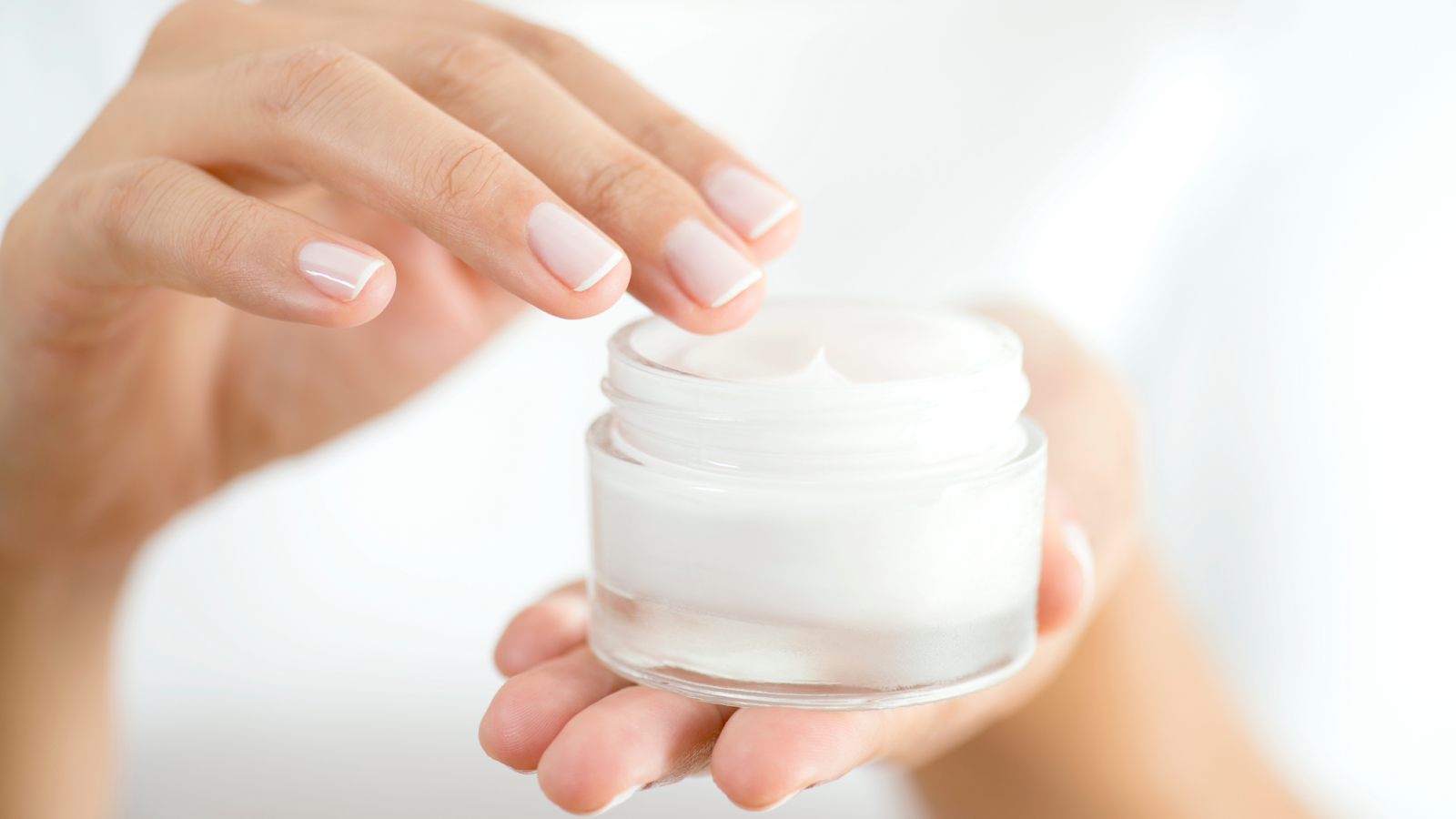 a woman holding facial moisturizer for dry skin 
