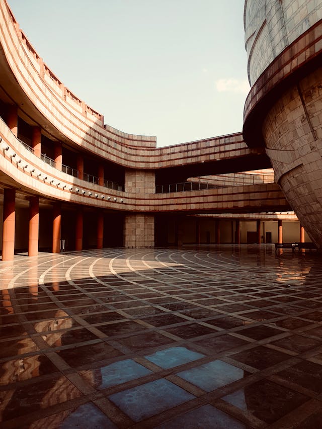 A courtyard overlooking circular bridges connecting two buildings designed using parametric design principles