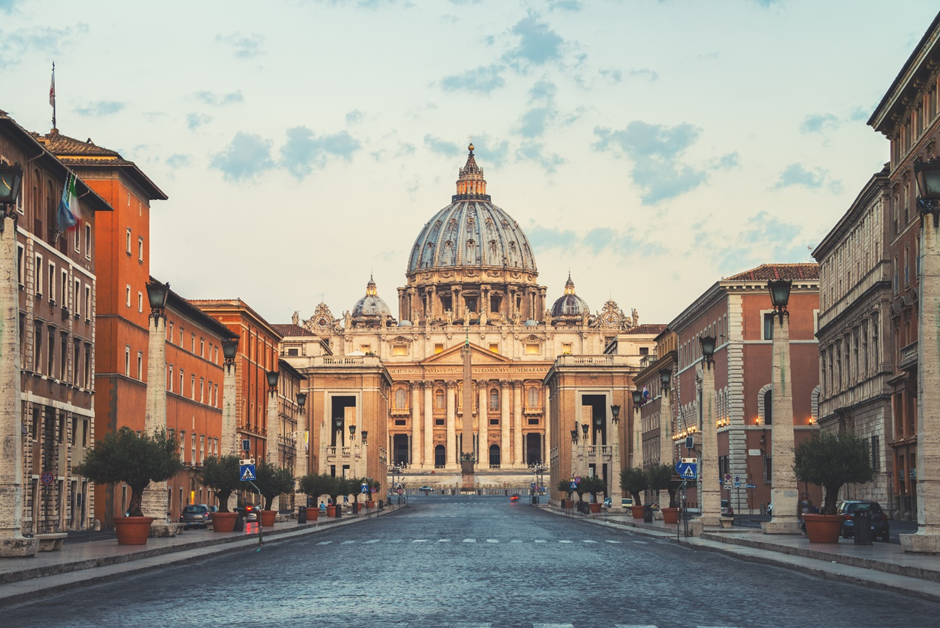 A street with a large building and a dome. The Vatican