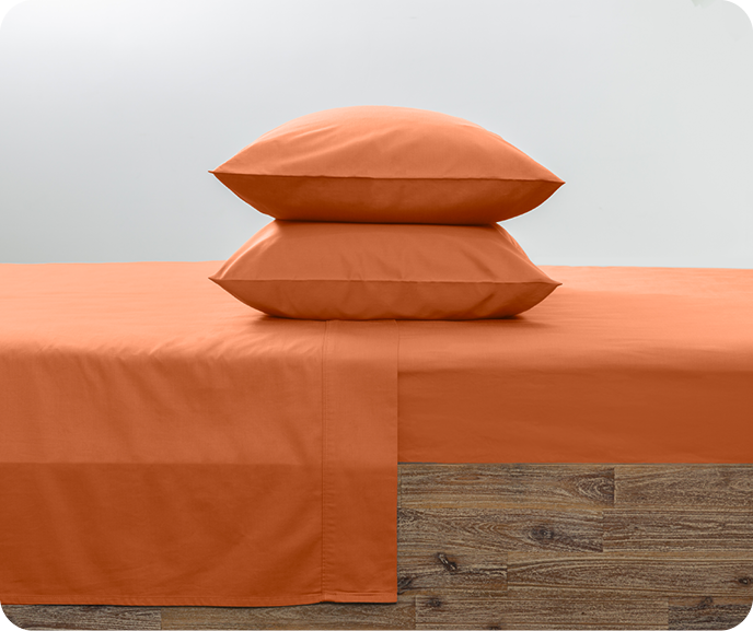 Our Bamboo Cotton Sheet Set in Apricot shown on a bed.