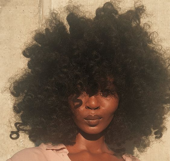 Lady poses for a selfie with her Bantu knot out