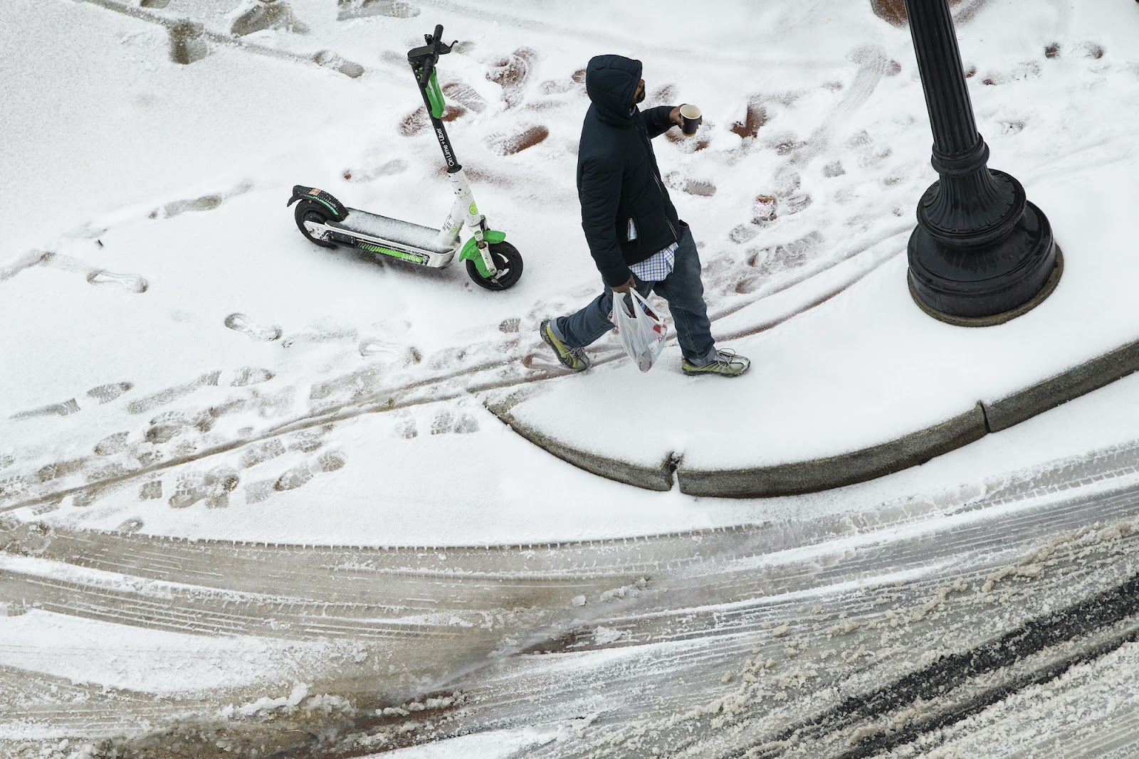 man with electric scooter on snow