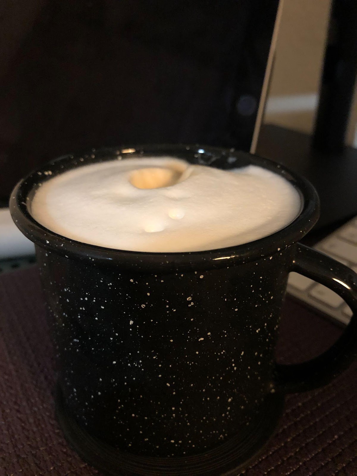A second cup of liquid with froth on top