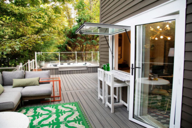 things to consider before investing in your composite deck trex decking with couch and bar area custom built michigan