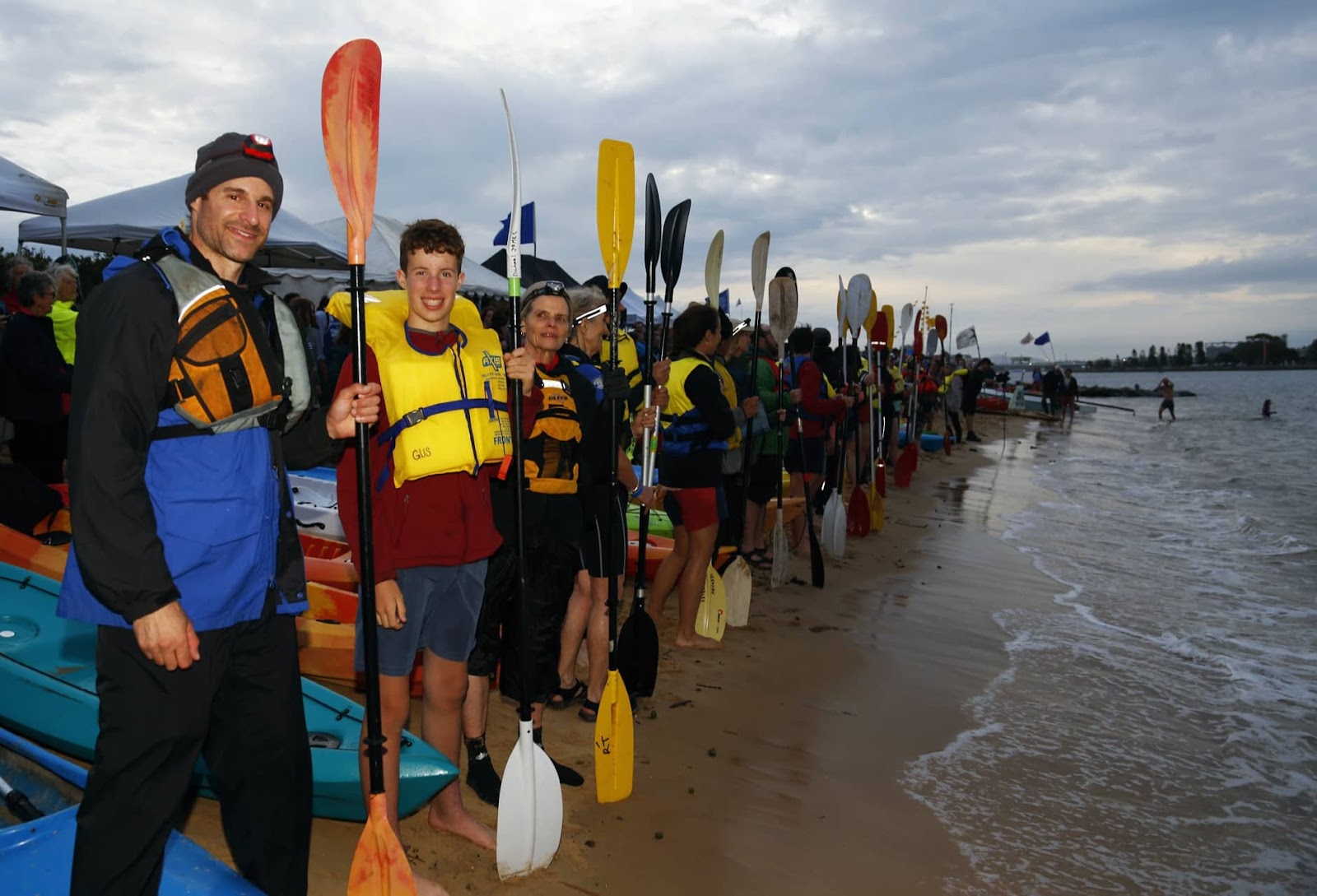 Protesters line up on the beach with their kayaks and oars for an evening blockade