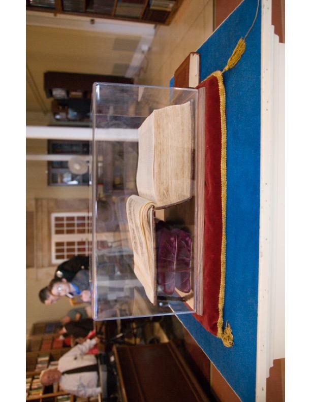 A clear acrylic box with a book inside

Description automatically generated