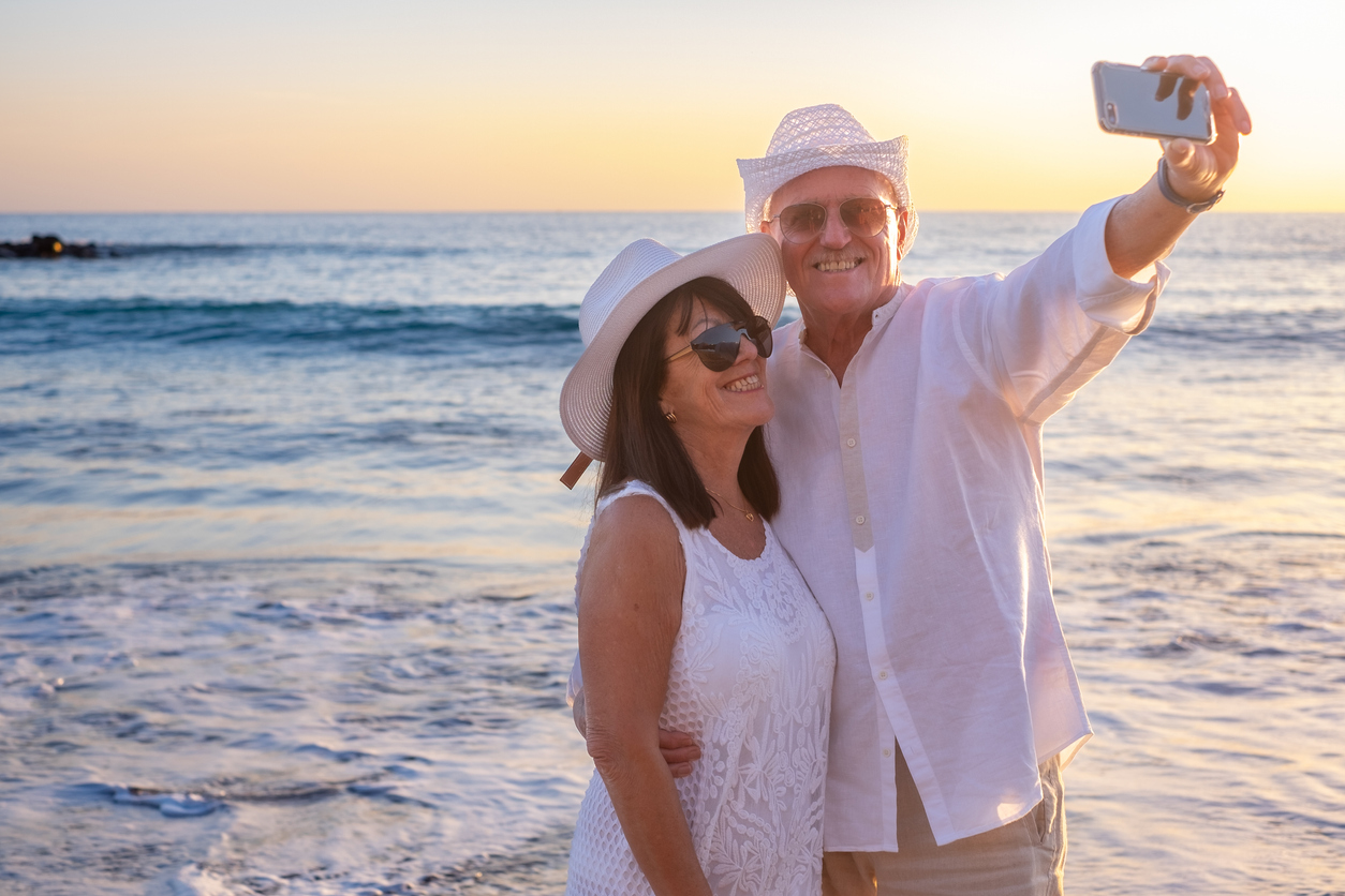 Seniors taking selfie on the beach