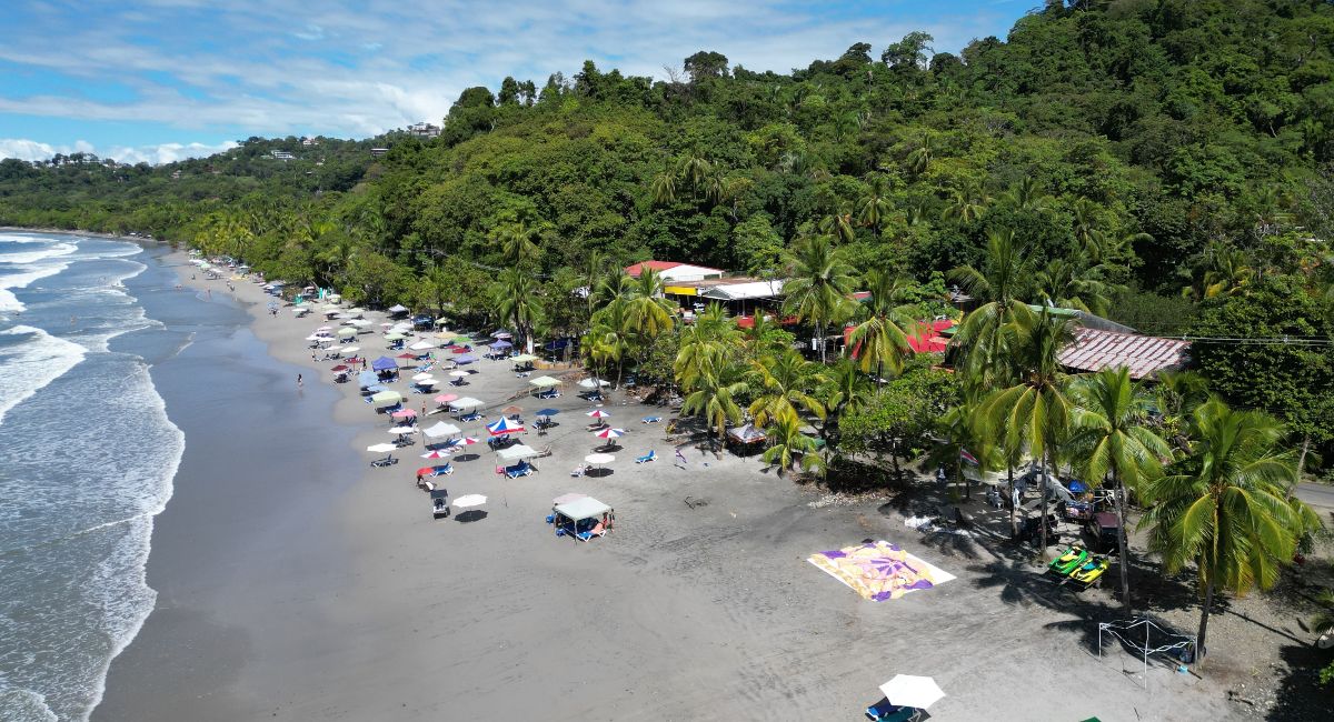 A sandy beach with palm trees near Jaco, Costa Rica