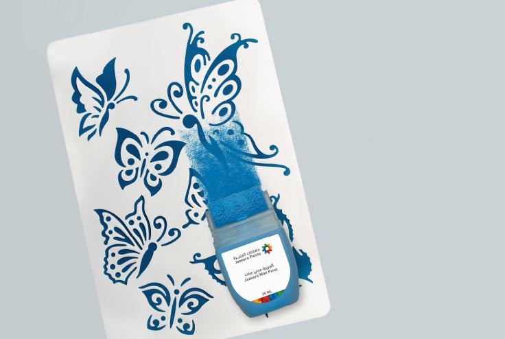 A blue paint brush on a white surface with butterflies

Description automatically generated