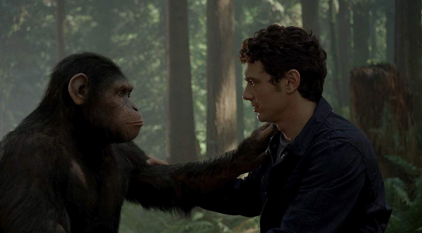 El personaje de James Franco tomándose del hombro con César en El planeta de los simios: revolución