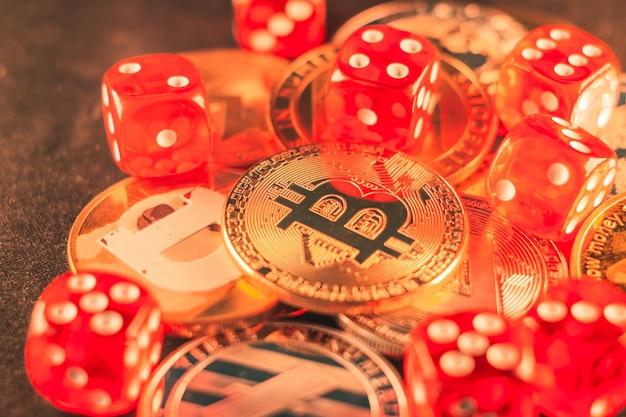 Closeup shot of some bitcoins and red dice