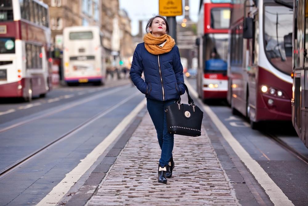 A person walking on a sidewalk

Description automatically generated